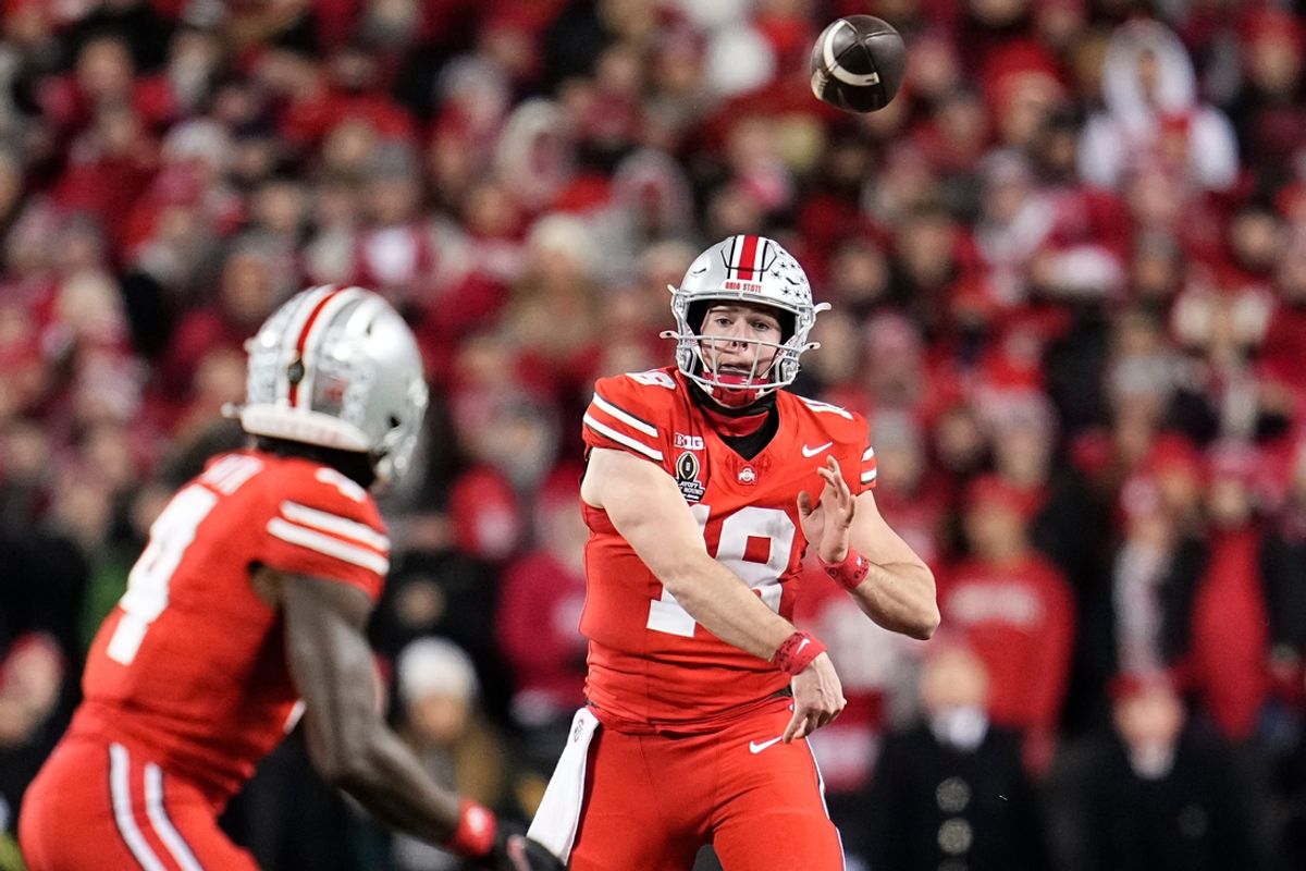 Ohio State Buckeyes quarterback Will Howard (18) throws to wide receiver Jeremiah Smith (4) during the first half of the College Football Playoff first round game against the Tennessee Volunteers at Ohio Stadium in Columbus on Dec. 21, 2024.