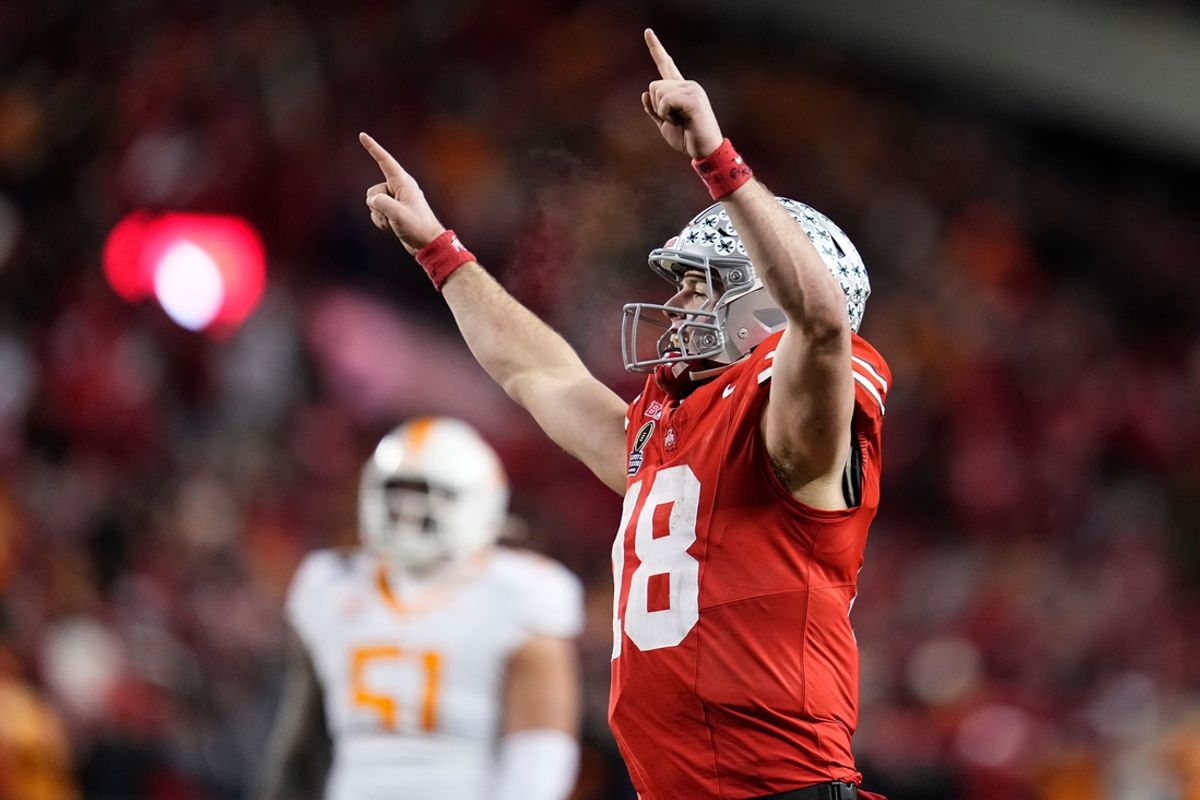 Ohio State Buckeyes quarterback Will Howard (18) celebrates a touchdown by running back TreVeyon Henderson during the second half of the College Football Playoff first round game against the Tennessee Volunteers at Ohio Stadium in Columbus on Dec. 22, 2024. Ohio State won 42-17.