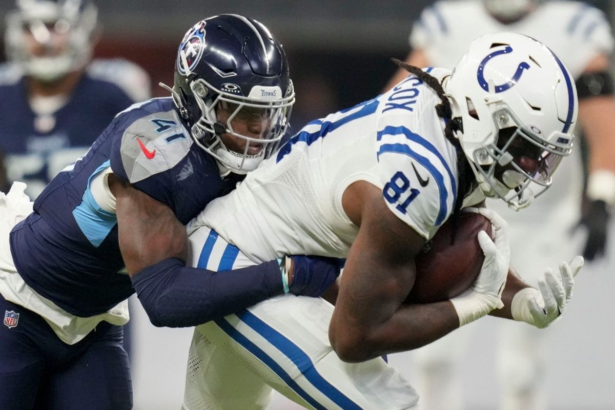 Tennessee Titans linebacker Otis Reese IV (41) tackles Indianapolis Colts tight end Mo Alie-Cox (81) on Sunday, Dec. 22, 2024, during a game against the Tennessee Titans at Lucas Oil Stadium in Indianapolis.
