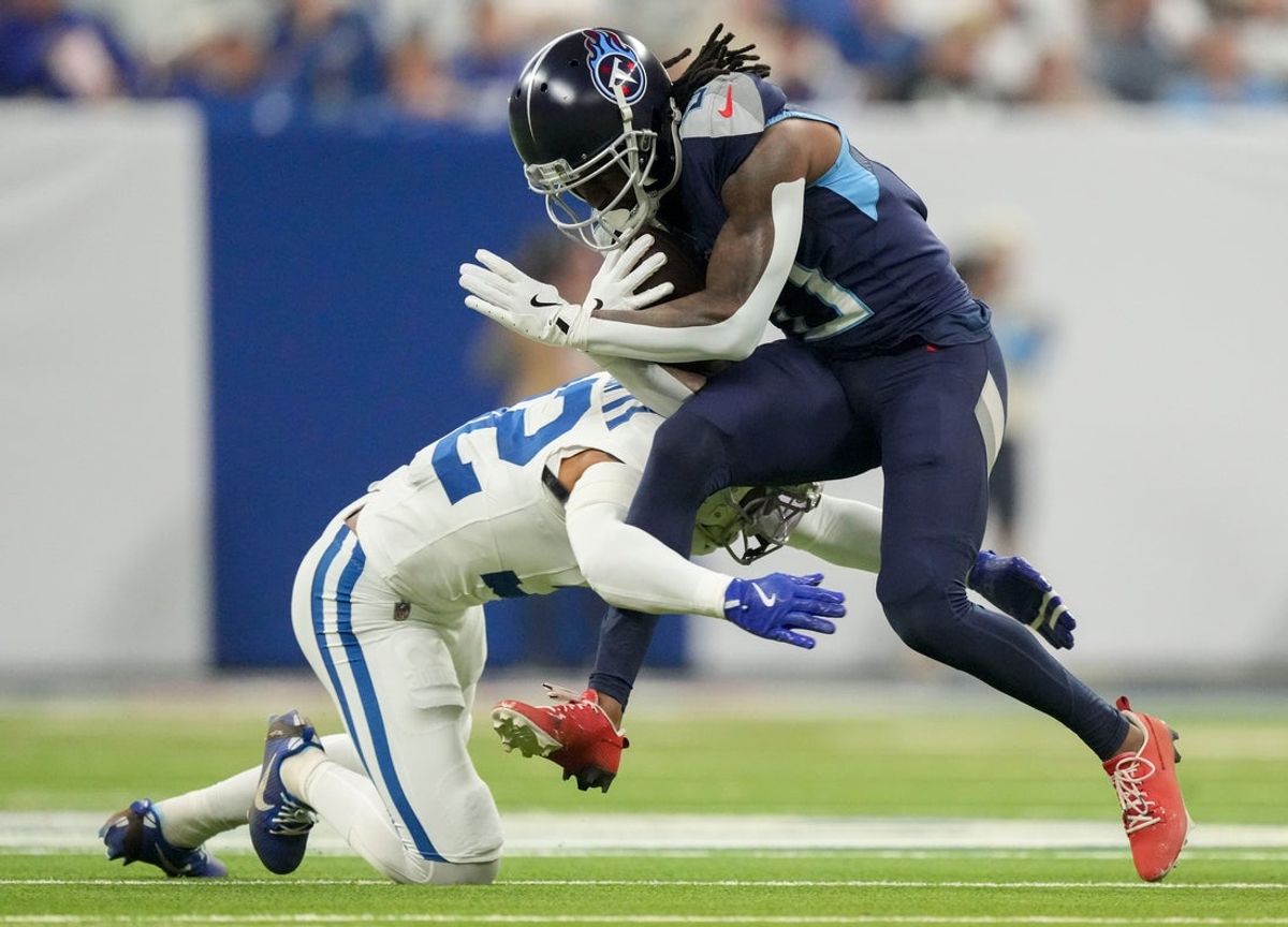 Indianapolis Colts safety Julian Blackmon (32) tackles Tennessee Titans wide receiver Calvin Ridley (0) on Sunday, Dec. 22, 2024, during a game against the Tennessee Titans at Lucas Oil Stadium in Indianapolis.