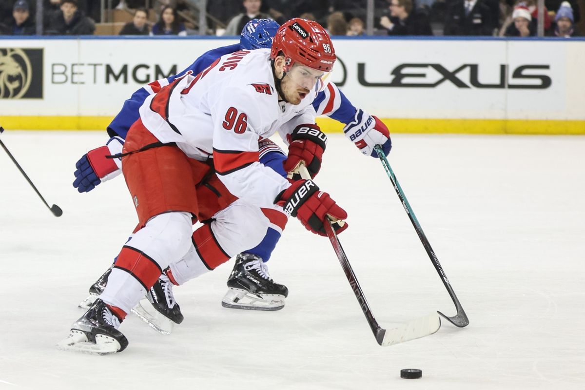 Dec 22, 2024; New York, New York, USA;  Carolina Hurricanes center Jack Roslovic (96) controls the puck in the second period against the New York Rangers at Madison Square Garden. Mandatory Credit: Wendell Cruz-Imagn Images