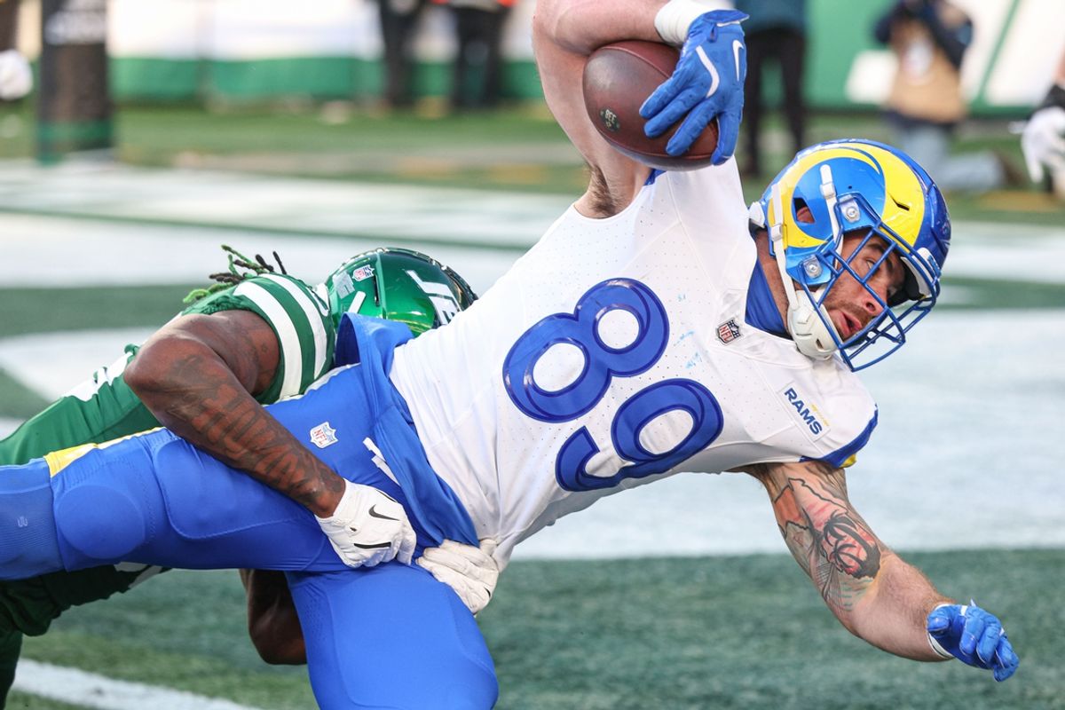 Dec 22, 2024; East Rutherford, New Jersey, USA; Los Angeles Rams tight end Tyler Higbee catches the ball a touchdown pass as New York Jets linebacker Quincy Williams (56) tackles during the second half at MetLife Stadium. Mandatory Credit: Vincent Carchietta-Imagn Images