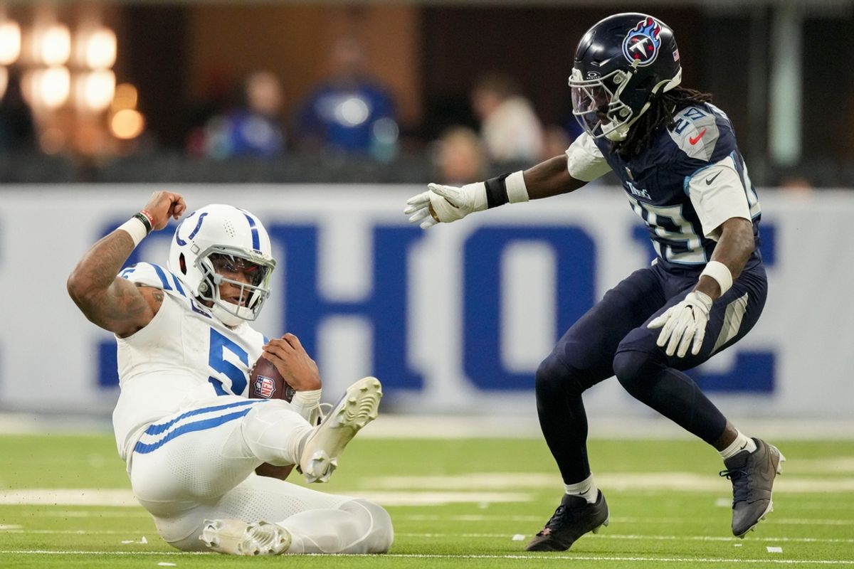 Indianapolis Colts quarterback Anthony Richardson (5) slides to the turf while rushing the ball as Tennessee Titans cornerback Jarvis Brownlee Jr. (29) rushes in Sunday, Dec. 22, 2024, during a game against the Tennessee Titans at Lucas Oil Stadium in Indianapolis.