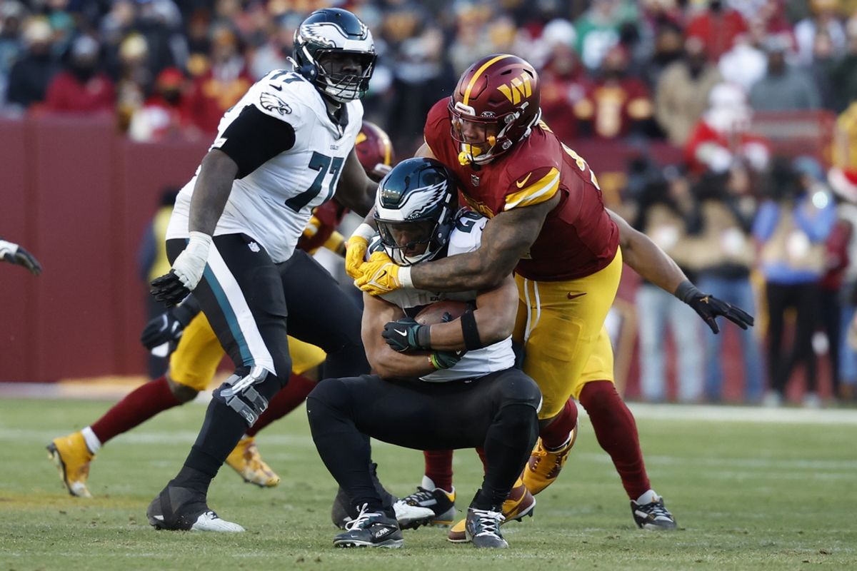 Dec 22, 2024; Landover, Maryland, USA; Philadelphia Eagles running back Saquon Barkley (26) is tackled by Washington Commanders defensive tackle Daron Payne (94) during the fourth quarter at Northwest Stadium. Mandatory Credit: Geoff Burke-Imagn Images