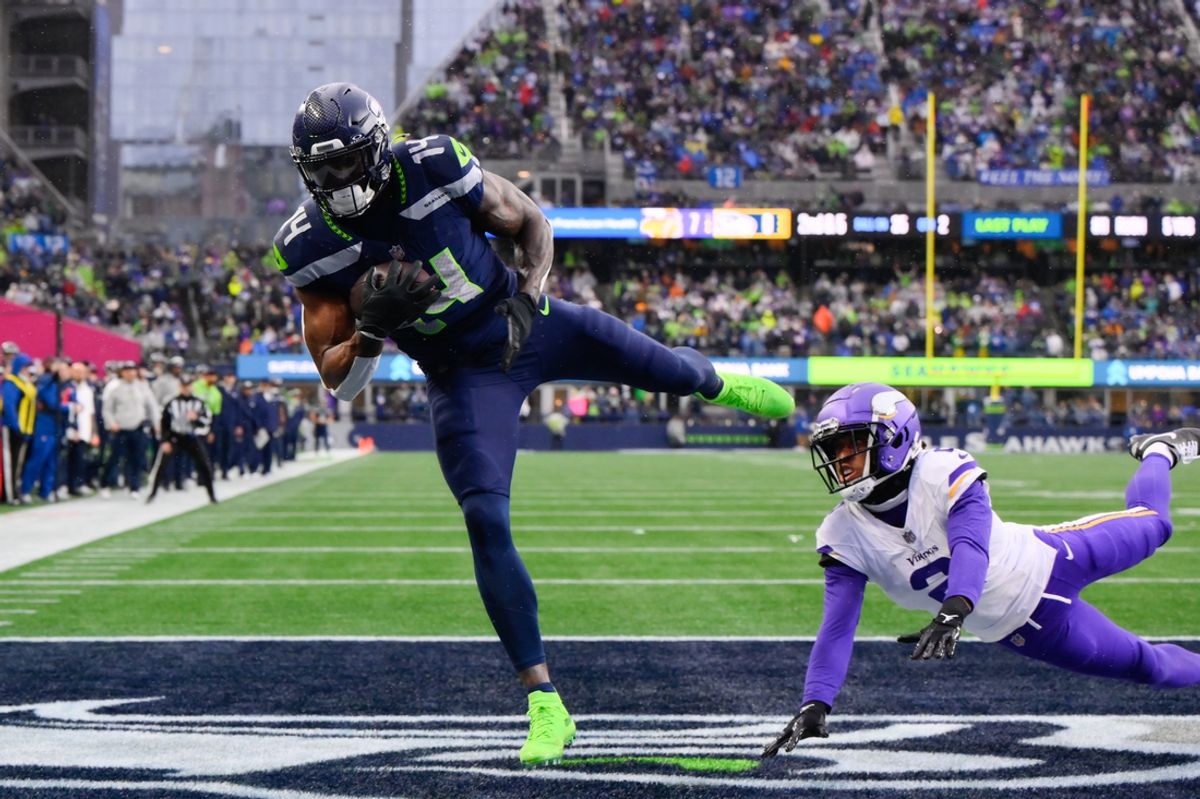 Dec 22, 2024; Seattle, Washington, USA; Seattle Seahawks wide receiver DK Metcalf (14) catches a pass for a touchdown over Minnesota Vikings cornerback Stephon Gilmore (2) during the first half at Lumen Field. Mandatory Credit: Steven Bisig-Imagn Images