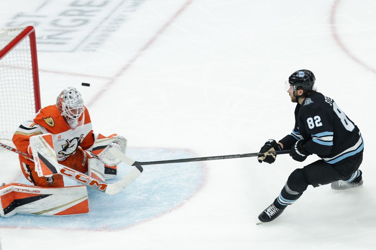 Dec 22, 2024; Salt Lake City, Utah, USA;  Utah Hockey Club center Kevin Stenlund (82) shoots over Anaheim Ducks goaltender Lukas Dostal (1) during the second period at Delta Center. Mandatory Credit: Chris Nicoll-Imagn Images