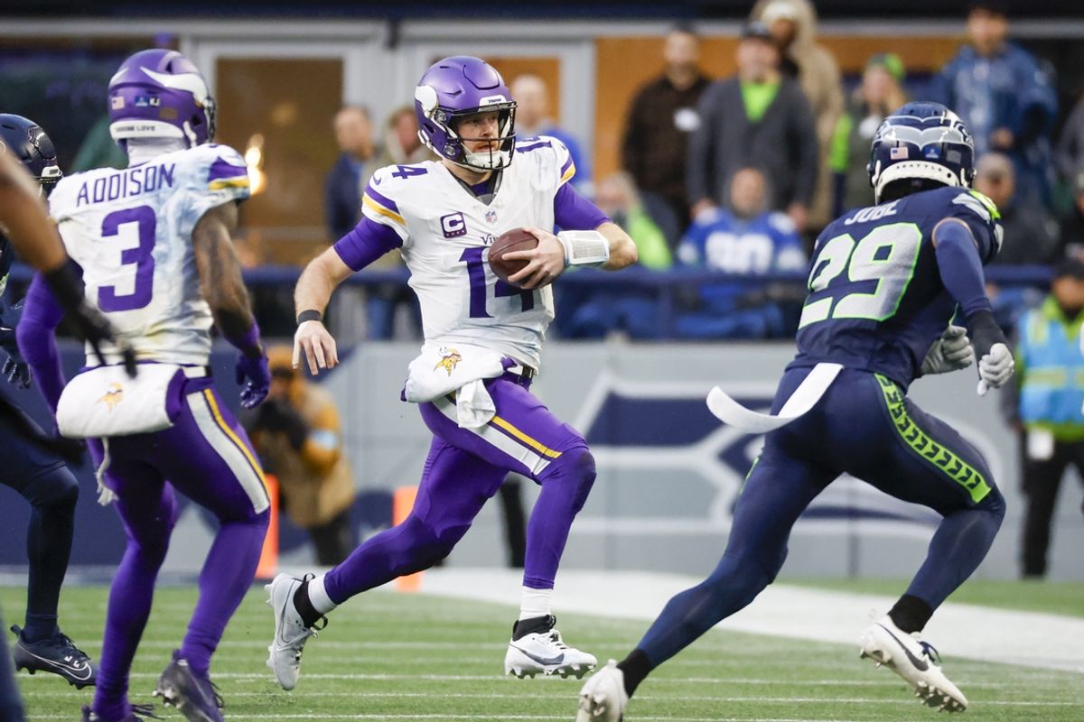 Dec 22, 2024; Seattle, Washington, USA; Minnesota Vikings quarterback Sam Darnold (14) rushes against the Seattle Seahawks during the fourth quarter at Lumen Field. Mandatory Credit: Joe Nicholson-Imagn Images