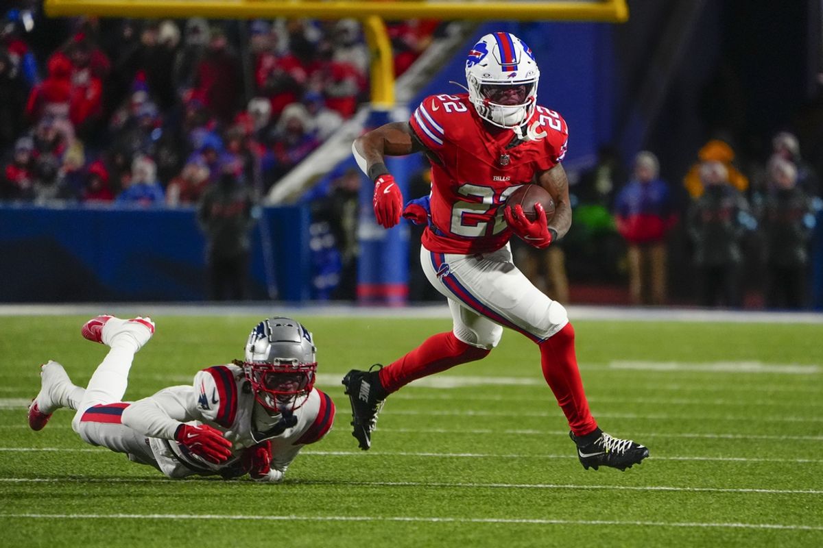 Dec 22, 2024; Orchard Park, New York, USA; Buffalo Bills running back Ray Davis (22) runs with the ball against New England Patriots cornerback Alex Austin (28) during the second half at Highmark Stadium. Mandatory Credit: Gregory Fisher-Imagn Images