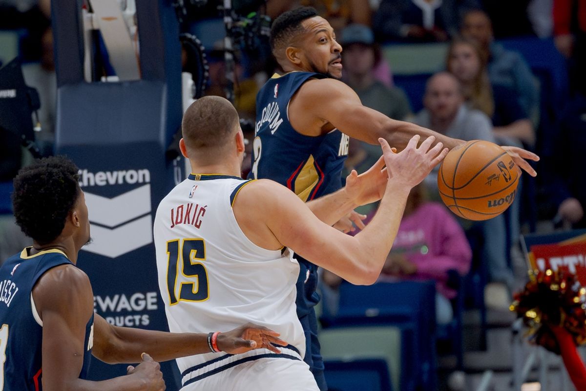 Dec 22, 2024; New Orleans, Louisiana, USA; New Orleans Pelicans guard CJ McCollum (3) blocks the shot of Denver Nuggets center Nikola Jokic (15) during the first half at Smoothie King Center. Mandatory Credit: Matthew Hinton-Imagn Images