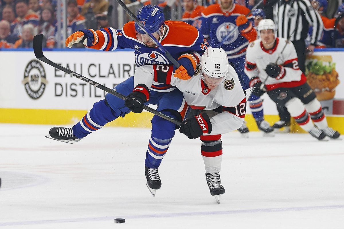 Dec 22, 2024; Edmonton, Alberta, CAN; Edmonton Oilers forward Victor Arvidsson (33) throws a hit on Ottawa Senators forward Shane Pinto (12) during the first period at Rogers Place. Mandatory Credit: Perry Nelson-Imagn Images