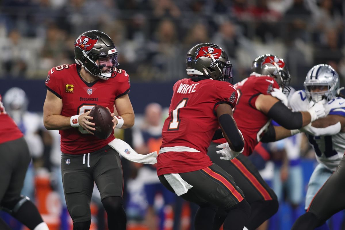 Dec 22, 2024; Arlington, Texas, USA; Tampa Bay Buccaneers quarterback Baker Mayfield (6) rolls out to pass against the Dallas Cowboys in the first quarter at AT&T Stadium. Mandatory Credit: Tim Heitman-Imagn Images