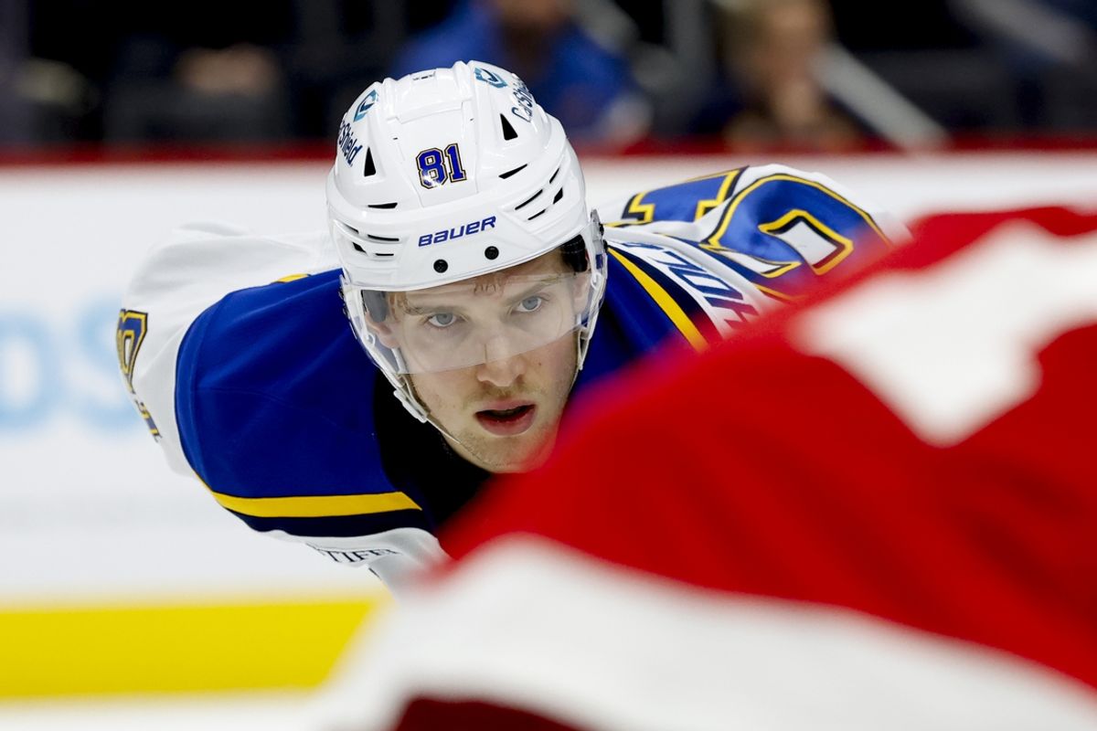 Dec 23, 2024; Detroit, Michigan, USA;  St. Louis Blues center Dylan Holloway (81) gets set during a face off in the first period against the Detroit Red Wings at Little Caesars Arena. Mandatory Credit: Rick Osentoski-Imagn Images
