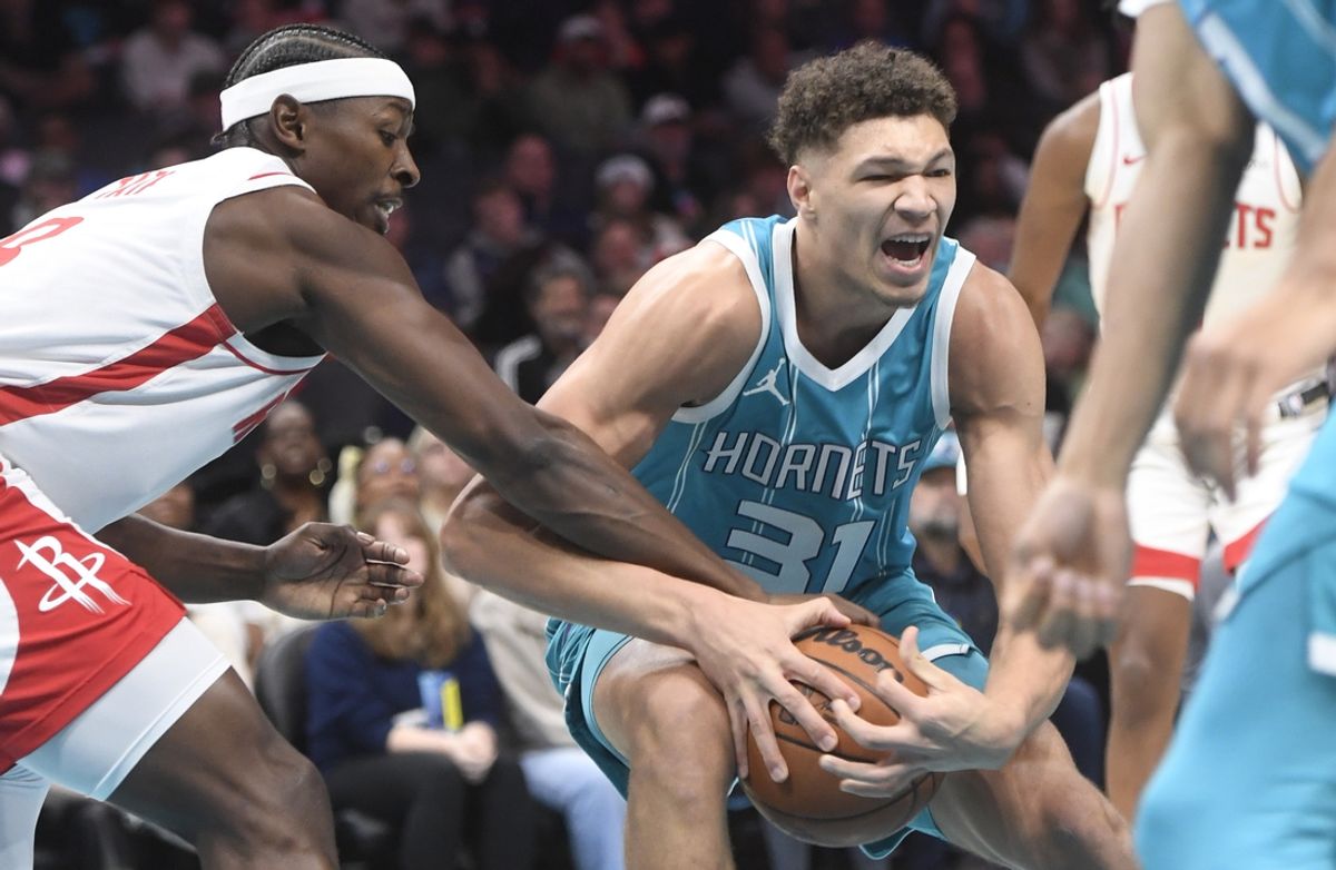 Dec 23, 2024; Charlotte, North Carolina, USA;  Charlotte Hornets forward Tidjane Salaun (31) gets the ball stripped by Houston Rockets forward Jae’ Sean Tate (8) during the first half at the Spectrum Center. Mandatory Credit: Sam Sharpe-Imagn Images