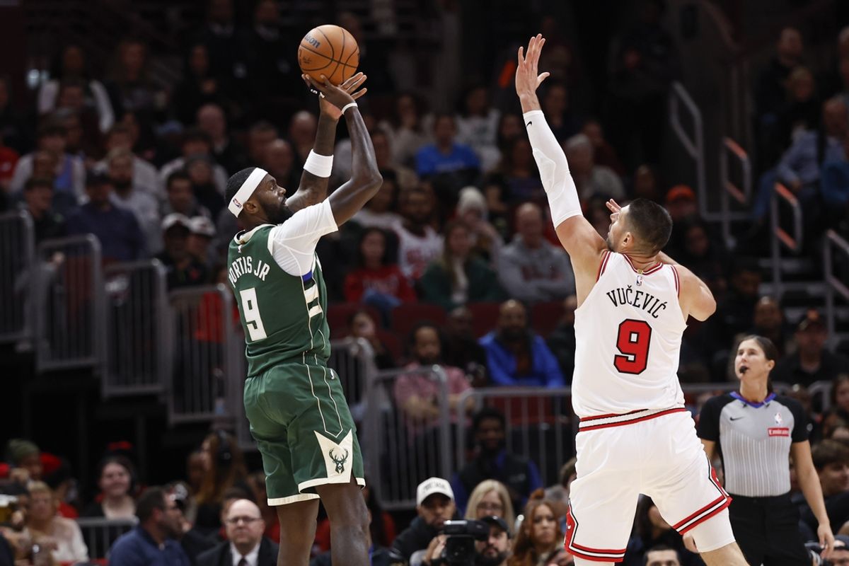 Dec 23, 2024; Chicago, Illinois, USA; Milwaukee Bucks forward Bobby Portis (9) shoots against Chicago Bulls center Nikola Vucevic (9) during the first half at United Center. Mandatory Credit: Kamil Krzaczynski-Imagn Images