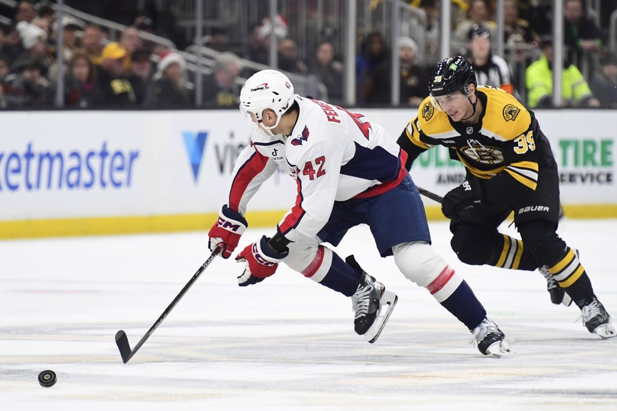 Dec 23, 2024; Boston, Massachusetts, USA;  Washington Capitals defenseman Martin Fehervary (42) skates after the puck while Boston Bruins center Morgan Geekie (39) pursues during the third period at TD Garden. Mandatory Credit: Bob DeChiara-Imagn Images