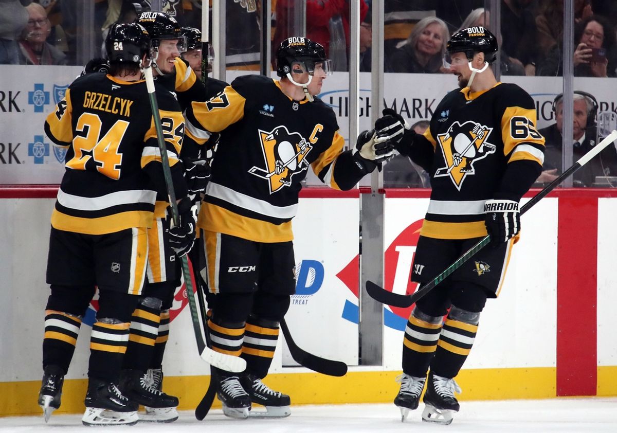 Dec 23, 2024; Pittsburgh, Pennsylvania, USA;  Pittsburgh Penguins center Sidney Crosby (87) celebrates his empty net goal with teammates including defenseman Matt Grzelcyk (24) and defenseman Erik Karlsson (65) against the Philadelphia Flyers during the third period at PPG Paints Arena. Mandatory Credit: Charles LeClaire-Imagn Images