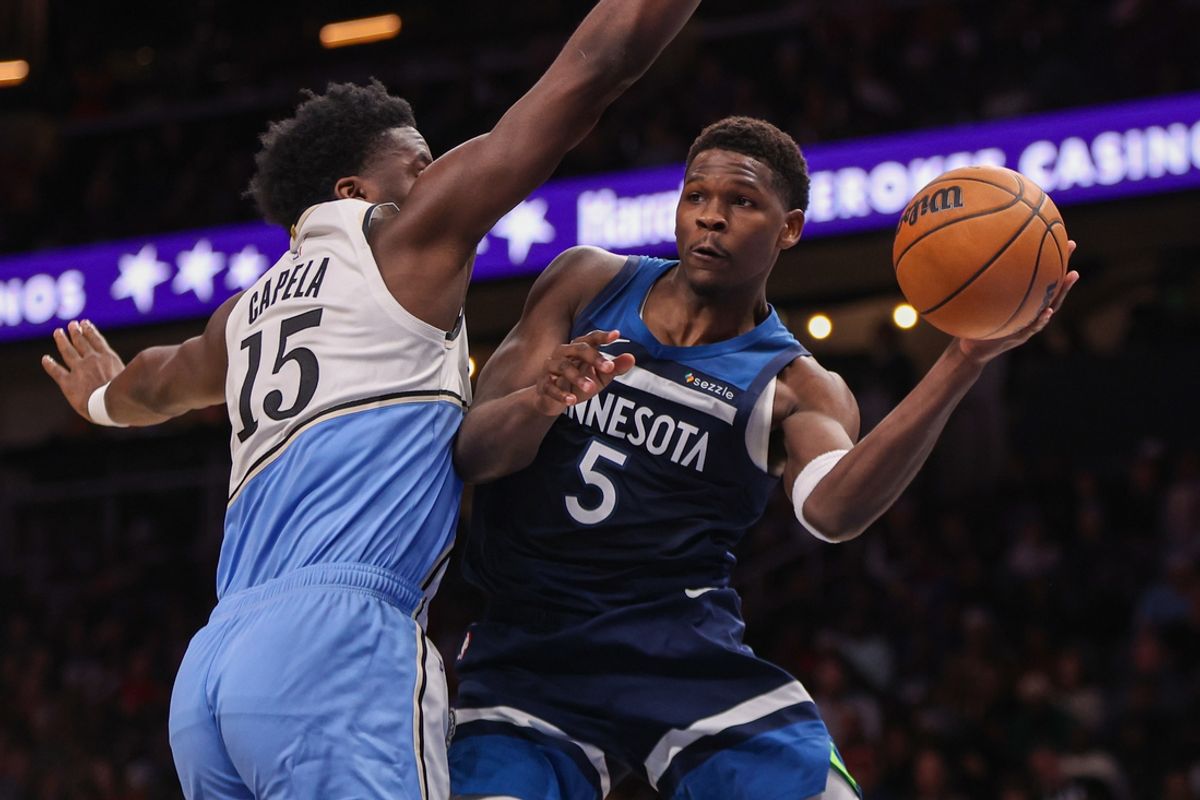 Dec 23, 2024; Atlanta, Georgia, USA; Minnesota Timberwolves guard Anthony Edwards (5) passes the ball around Atlanta Hawks center Clint Capela (15) in the fourth quarter at State Farm Arena. Mandatory Credit: Brett Davis-Imagn Images