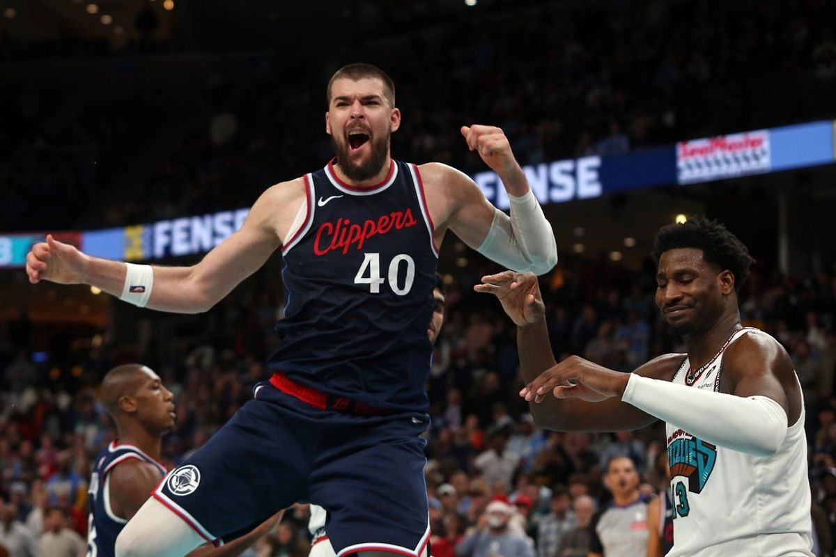 Dec 23, 2024; Memphis, Tennessee, USA; Los Angeles Clippers center Ivica Zubac (40) reacts after a dunk over Memphis Grizzlies forward Jaren Jackson Jr. (13) during the fourth quarter at FedExForum. Mandatory Credit: Petre Thomas-Imagn Images