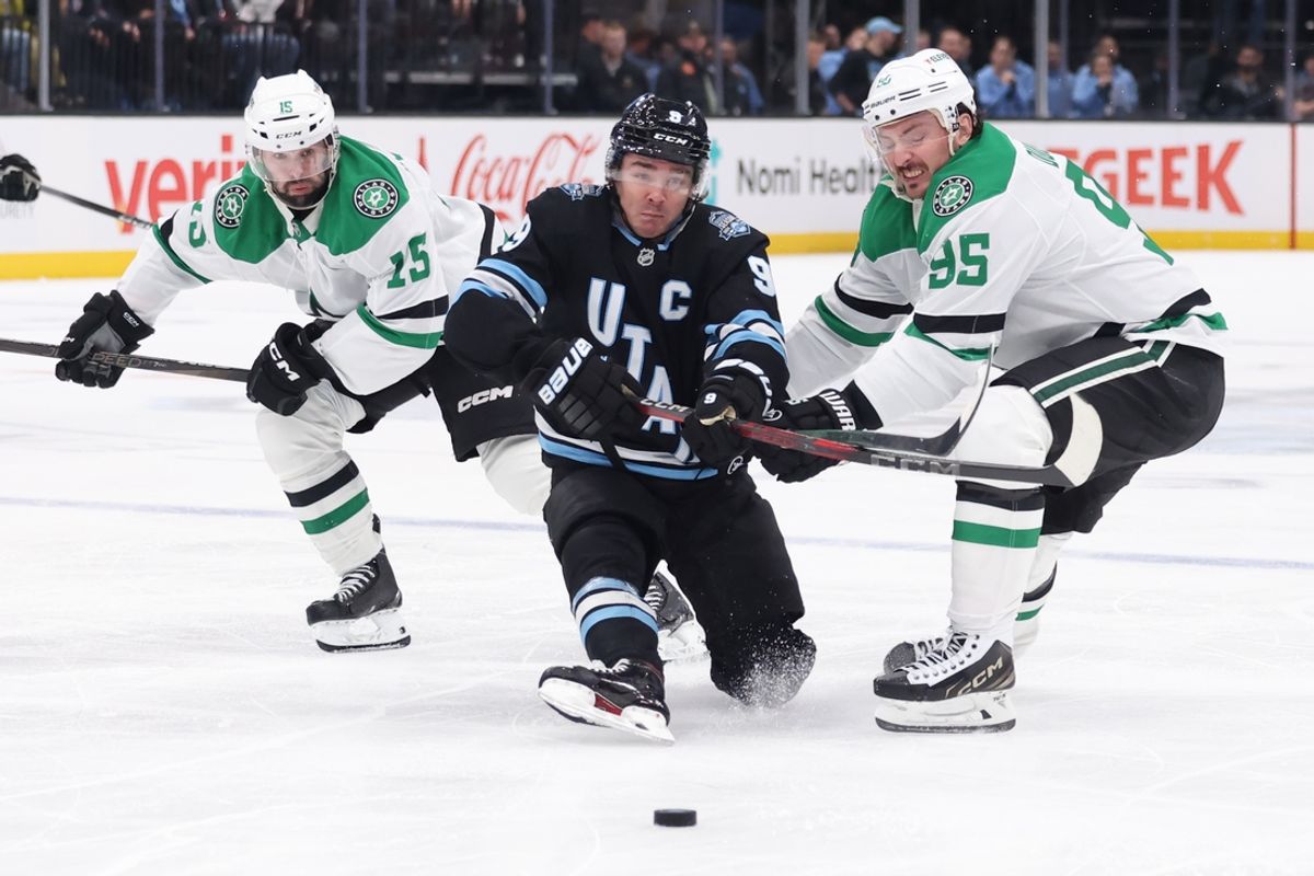 Dec 23, 2024; Salt Lake City, Utah, USA; Utah Hockey Club center Clayton Keller (9) battles for the puck against Dallas Stars center Colin Blackwell (15) and center Matt Duchene (95) during the second period at Delta Center. Mandatory Credit: Rob Gray-Imagn Images
