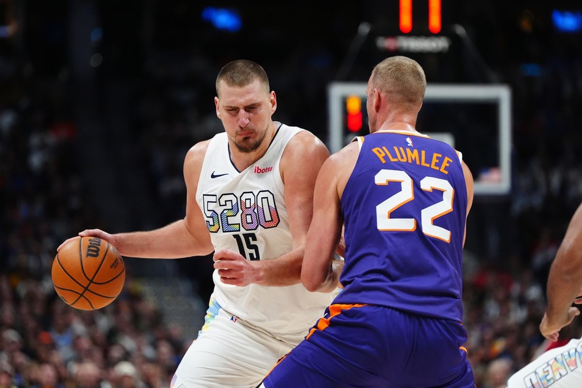 Dec 23, 2024; Denver, Colorado, USA; Phoenix Suns center Mason Plumlee (22) blocks Denver Nuggets center Nikola Jokic (15) in the second half at Ball Arena. Mandatory Credit: Ron Chenoy-Imagn Images