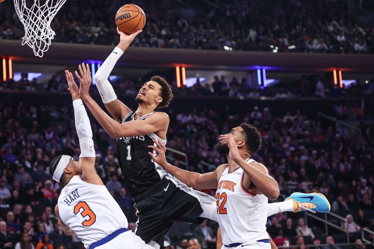 Dec 25, 2024; New York, New York, USA;  San Antonio Spurs center Victor Wembanyama (1) shoots over New York Knicks guard Josh Hart (3) in the first quarter at Madison Square Garden. Mandatory Credit: Wendell Cruz-Imagn Images