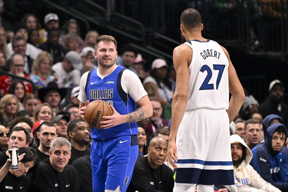 Dec 25, 2024; Dallas, Texas, USA; Dallas Mavericks guard Luka Doncic (77) exchanges words with Minnesota Timberwolves center Rudy Gobert (27) during the first quarter at the American Airlines Center. Mandatory Credit: Jerome Miron-Imagn Images