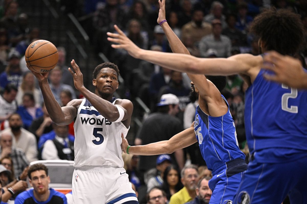 Dec 25, 2024; Dallas, Texas, USA; Minnesota Timberwolves guard Anthony Edwards (5) passes the ball by Dallas Mavericks guard Spencer Dinwiddie (26) during the second quarter at the American Airlines Center. Mandatory Credit: Jerome Miron-Imagn Images