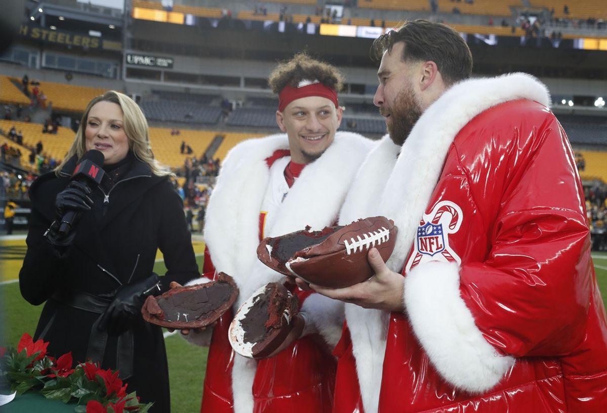 Dec 25, 2024; Pittsburgh, Pennsylvania, USA;  Kansas City Chiefs quarterback Patrick Mahomes (middle) and tight end Travis Kelce (right) open their Netflix Christmas GameDay cake after the Chiefs defeated the Pittsburgh Steelers at Acrisure Stadium. Mandatory Credit: Charles LeClaire-Imagn Images