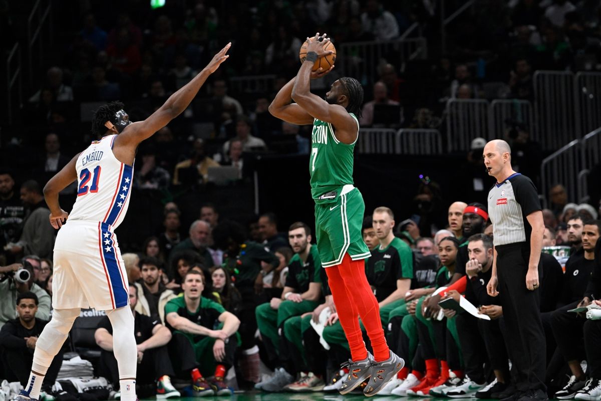 Dec 25, 2024; Boston, Massachusetts, USA; Boston Celtics guard Jaylen Brown (7) shoots the ball against Philadelphia 76ers center Joel Embiid (21) Boston Celtics during the first half at TD Garden. Mandatory Credit: Eric Canha-Imagn Images