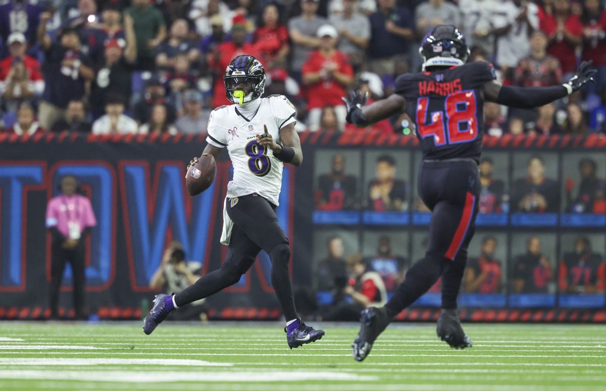 Dec 15, 2024; Houston, Texas, USA; Baltimore Ravens quarterback Lamar Jackson (8) scrambles with the ball during the second quarter against the Houston Texans at NRG Stadium. Mandatory Credit: Troy Taormina-Imagn Images