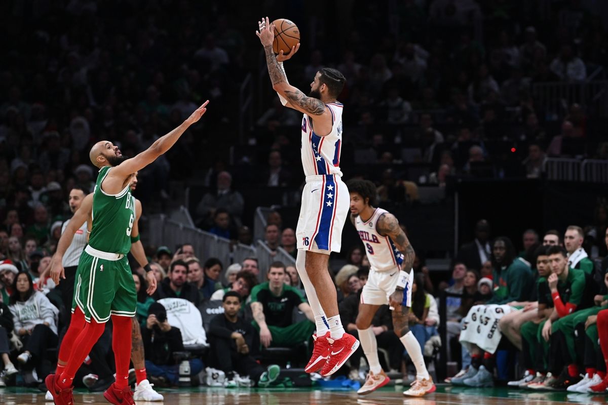 Dec 25, 2024; Boston, Massachusetts, USA; Philadelphia 76ers forward Caleb Martin (16) shoots over Boston Celtics guard Derrick White (9) during the second half at TD Garden. Mandatory Credit: Eric Canha-Imagn Images