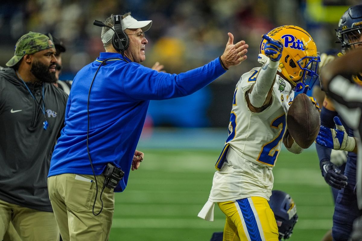 Pittsburgh Panthers head coach Pat Narduzzi hits Pittsburgh Panthers running back Juelz Goff (26) on the helmet after getting a first down, during the first half of the 2024 GameAbove Sports Bowl at Ford Field in Detroit, Thursday, Dec. 26, 2024.