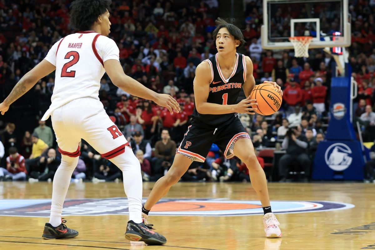 Dec 21, 2024; Newark, New Jersey, USA; Princeton Tigers guard Xaivian Lee (1) looks to pass while being defended by Rutgers Scarlet Knights guard Dylan Harper (2) during the second half at Prudential Center. Mandatory Credit: Tom Horak-Imagn Images