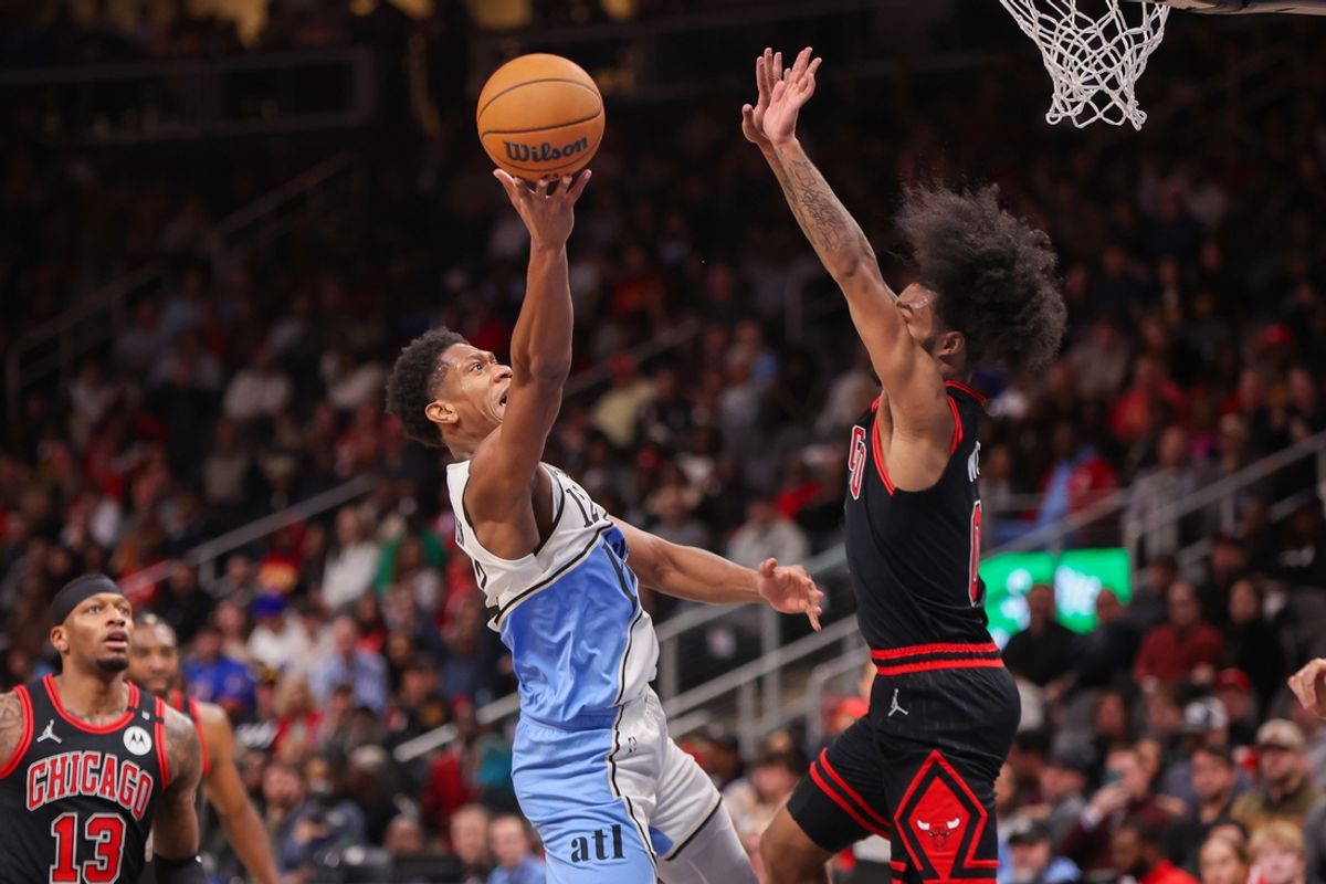 Dec 26, 2024; Atlanta, Georgia, USA; Atlanta Hawks forward De'Andre Hunter (12) shoots past Chicago Bulls guard Coby White (0) in the second quarter at State Farm Arena. Mandatory Credit: Brett Davis-Imagn Images