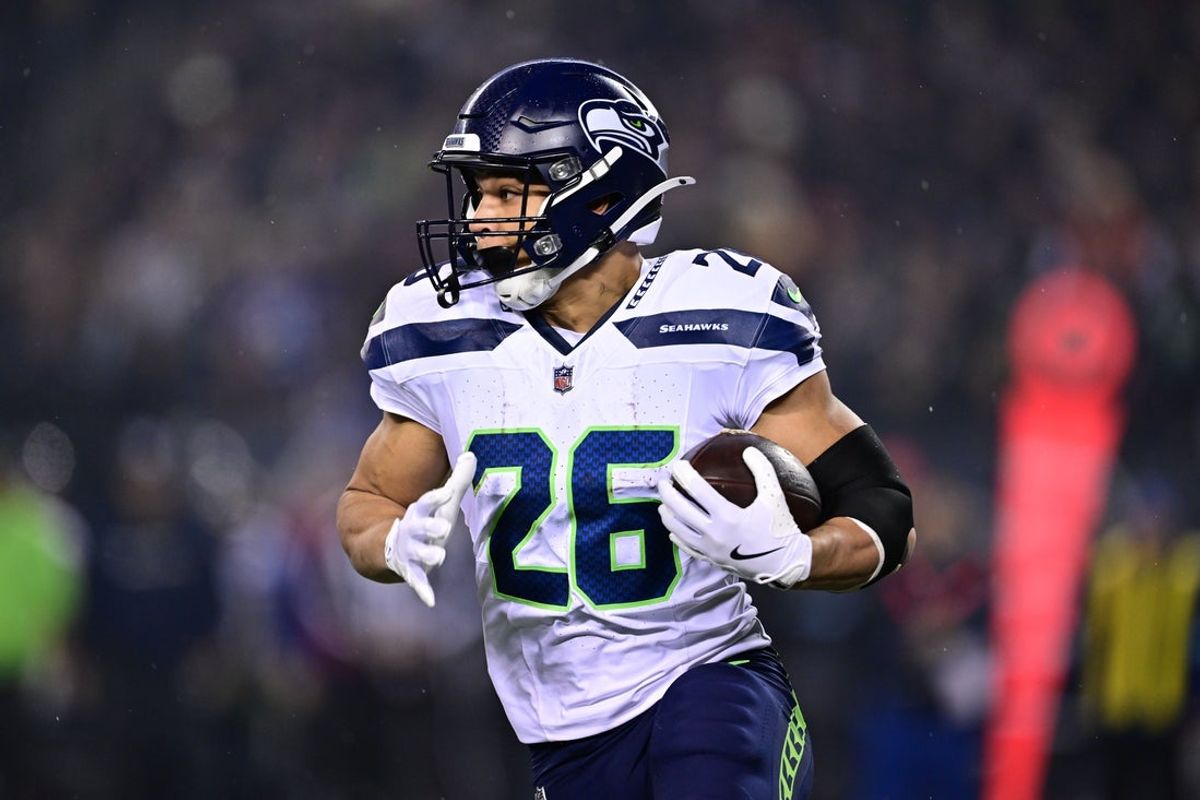 Dec 26, 2024; Chicago, Illinois, USA; Seattle Seahawks running back Zach Charbonnet (26) runs the ball against the Chicago Bears during the first quarter at Soldier Field. Mandatory Credit: Daniel Bartel-Imagn Images