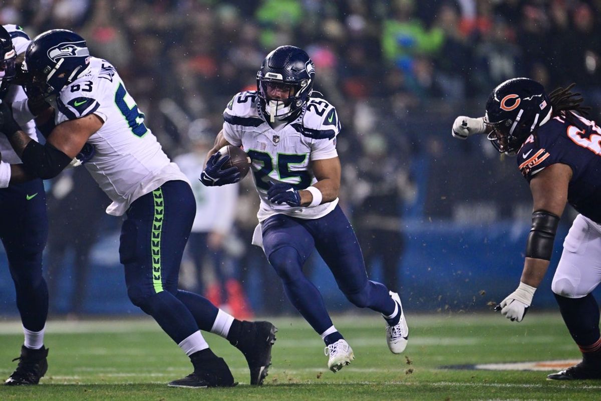 Dec 26, 2024; Chicago, Illinois, USA; Seattle Seahawks running back Kenny McIntosh (25) runs the ball against the Chicago Bears during the first quarter at Soldier Field. Mandatory Credit: Daniel Bartel-Imagn Images
