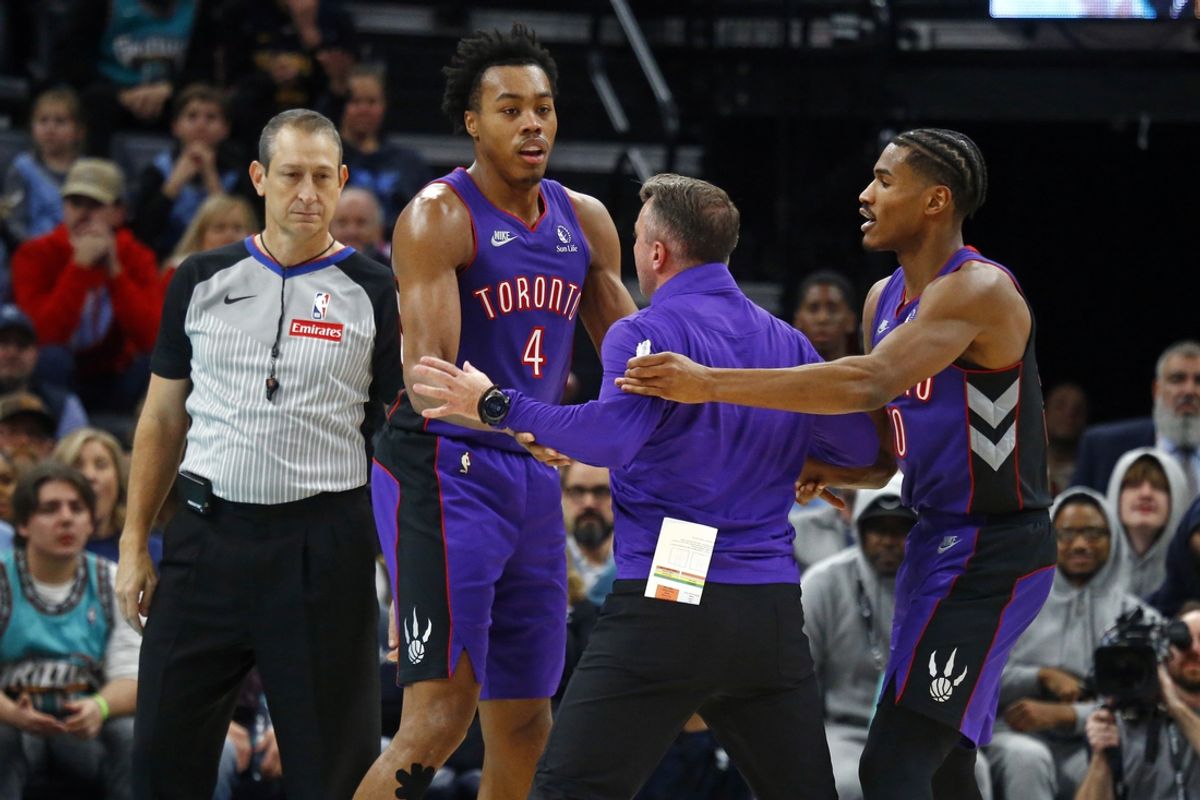 Dec 26, 2024; Memphis, Tennessee, USA; Toronto Raptors head coach Darko Rajakovic (middle) is held back by forward Scottie Barnes (4) and guard Ochai Agbaji (30) after interacting with the official during the fourth quarter against the Memphis Grizzlies at FedExForum. Mandatory Credit: Petre Thomas-Imagn Images