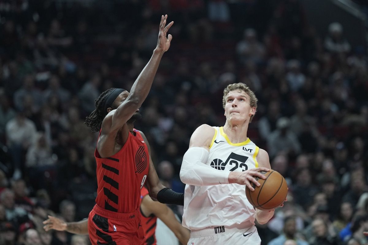 Dec 26, 2024; Portland, Oregon, USA; Utah Jazz power forward Lauri Markkanen (23) drives to the basket against Portland Trail Blazers small forward Jerami Grant (9) during the first half at Moda Center. Mandatory Credit: Soobum Im-Imagn Images