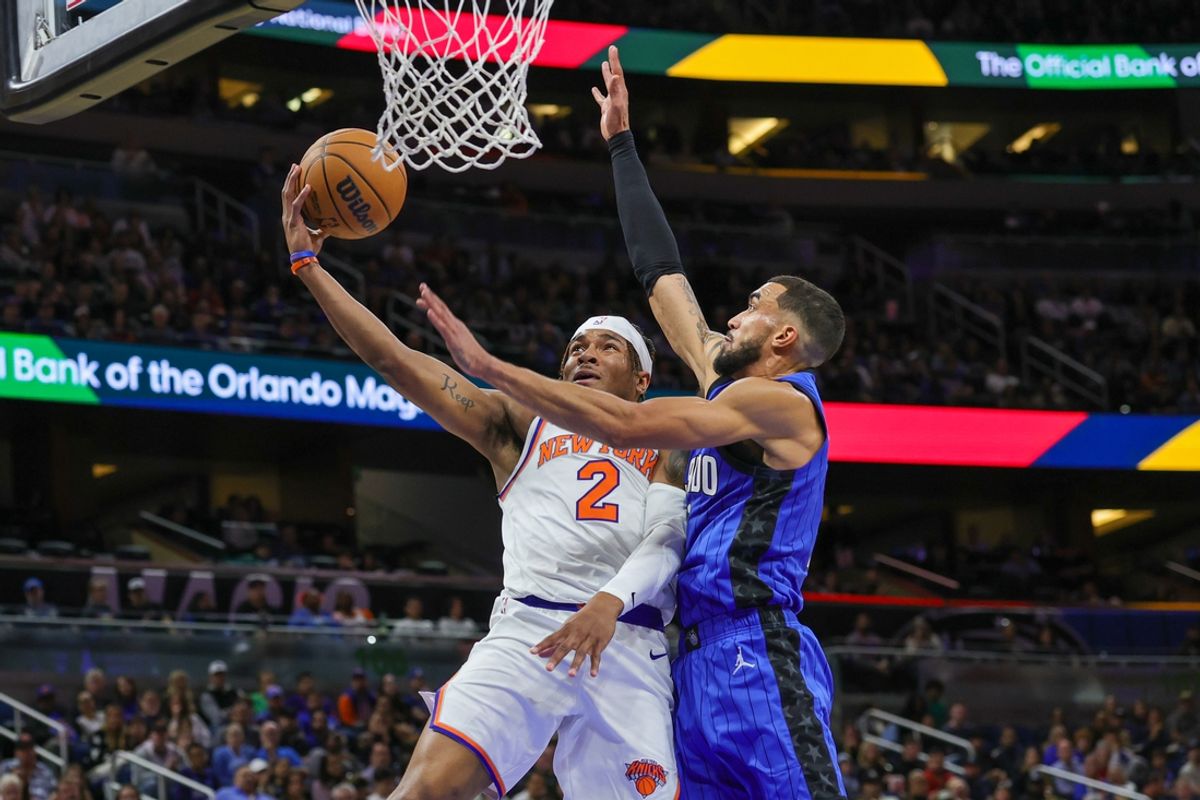 Dec 27, 2024; Orlando, Florida, USA; New York Knicks guard Miles McBride (2) is fouled by Orlando Magic guard Trevelin Queen (12) during the second quarter at Kia Center. Mandatory Credit: Mike Watters-Imagn Images