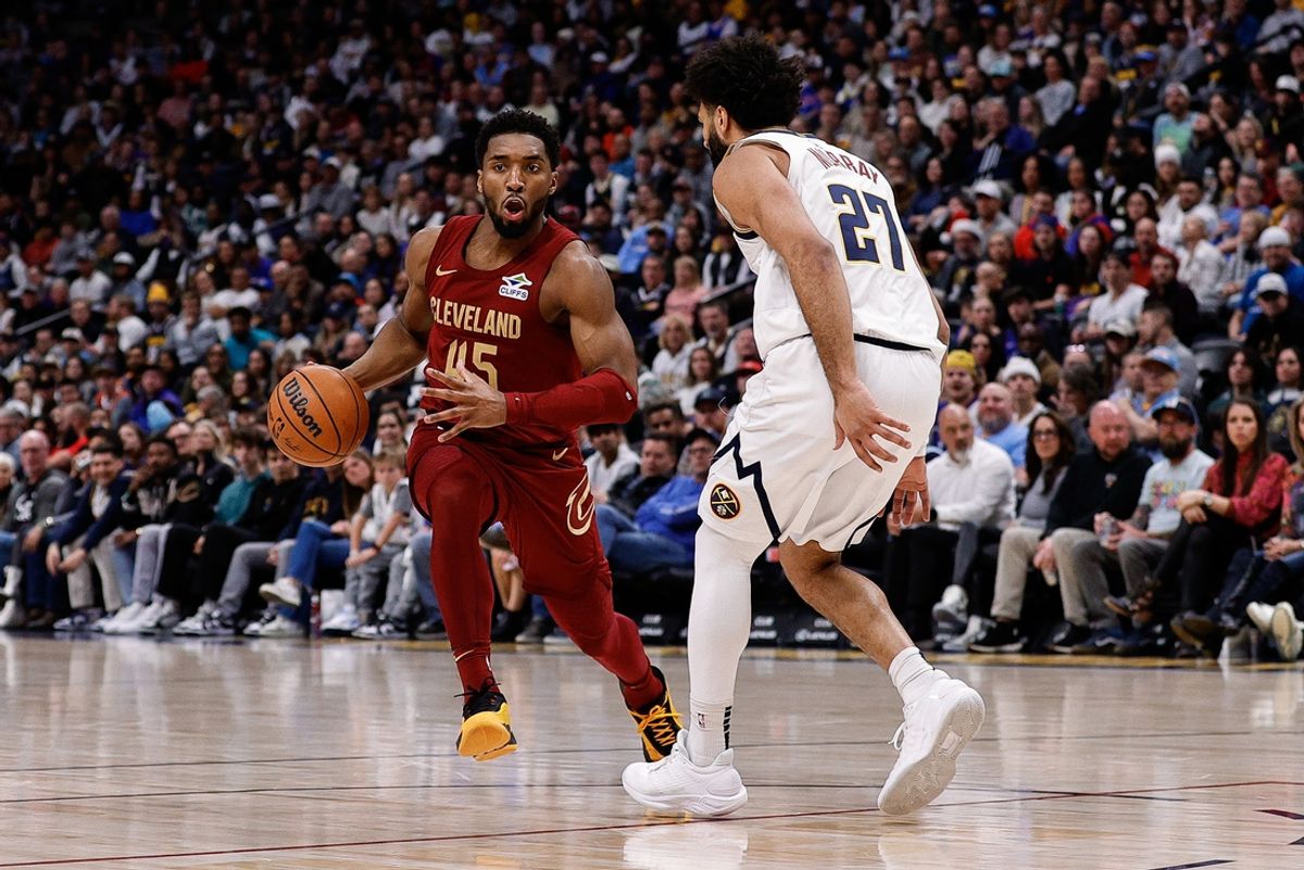Dec 27, 2024; Denver, Colorado, USA; Cleveland Cavaliers guard Donovan Mitchell (45) controls the ball as Denver Nuggets guard Jamal Murray (27) guards in the first quarter at Ball Arena. Mandatory Credit: Isaiah J. Downing-Imagn Images