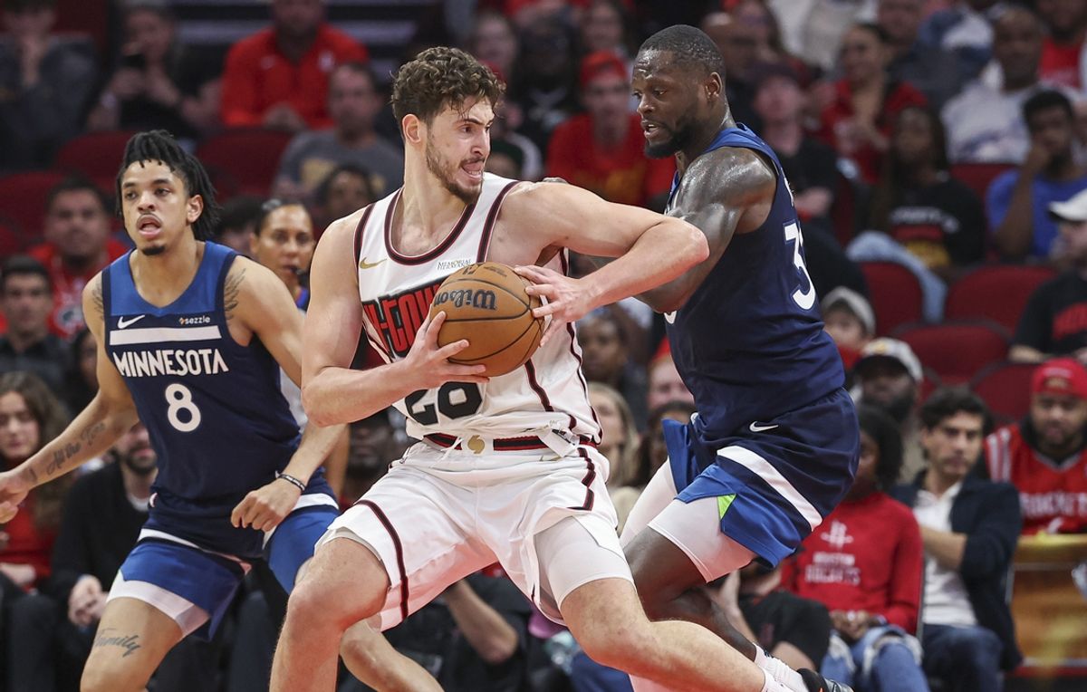 Dec 27, 2024; Houston, Texas, USA; Houston Rockets center Alperen Sengun (28) controls the ball as Minnesota Timberwolves forward Julius Randle (30) defends during the second quarter at Toyota Center. Mandatory Credit: Troy Taormina-Imagn Images