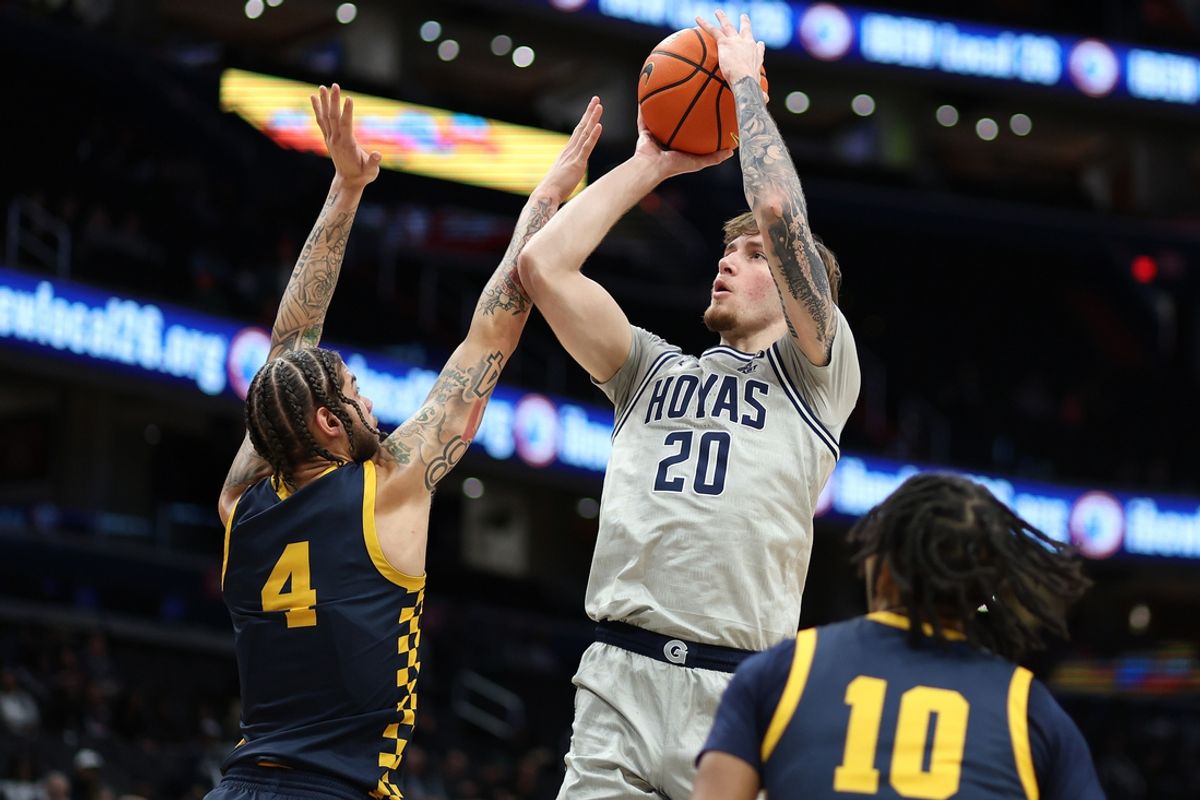 Dec 28, 2024; Washington, District of Columbia, USA; Georgetown Hoyas forward Drew Fielder (20) shoots the ball against Coppin State Eagles forward Khali Horton (4) and guard Camaren Sparrow (10) during the first half at Capital One Arena. Mandatory Credit: Daniel Kucin Jr.-Imagn Images
