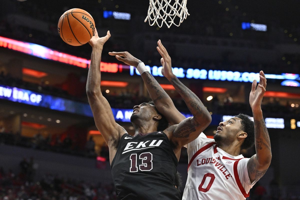 Dec 28, 2024; Louisville, Kentucky, USA;  Eastern Kentucky Colonels forward Montavious Myrick (13) battles Louisville Cardinals forward James Scott (0) for the ball during the first half at KFC Yum! Center. Mandatory Credit: Jamie Rhodes-Imagn Images