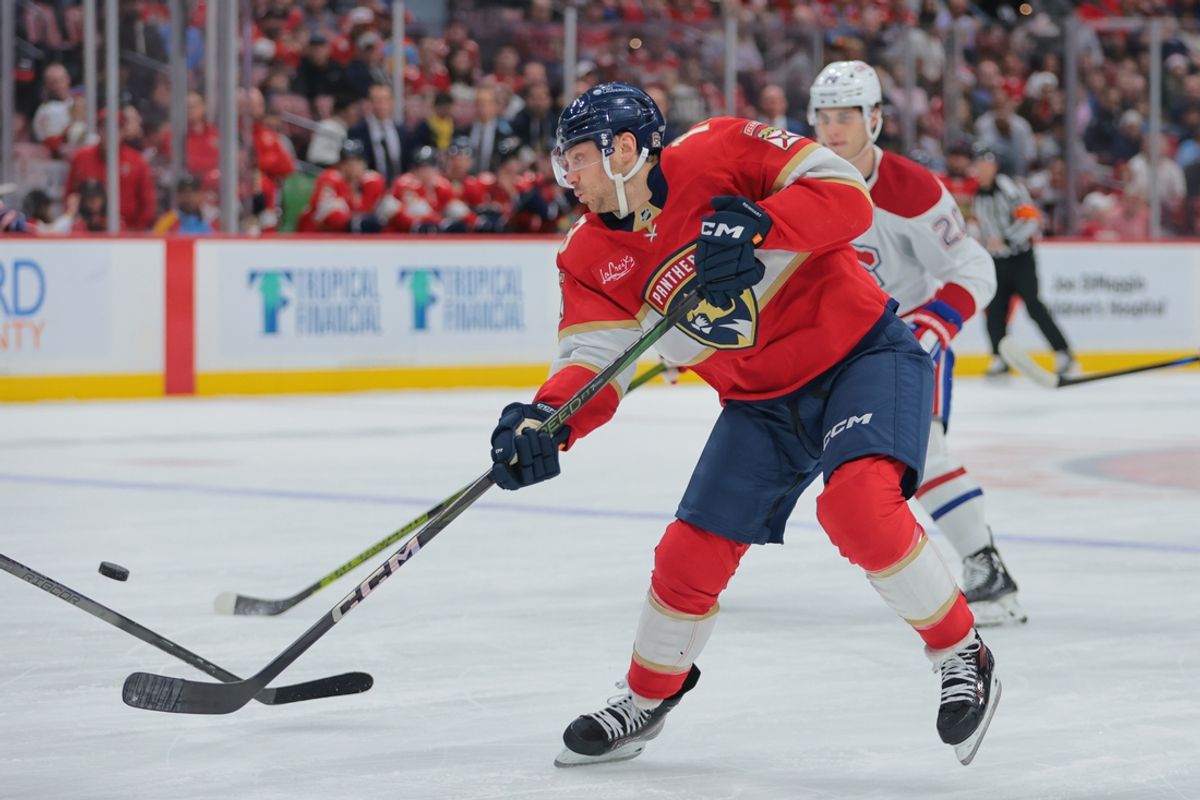 Dec 28, 2024; Sunrise, Florida, USA; Florida Panthers center Sam Reinhart (13) shoots the puck against the Montreal Canadiens during the first period at Amerant Bank Arena. Mandatory Credit: Sam Navarro-Imagn Images