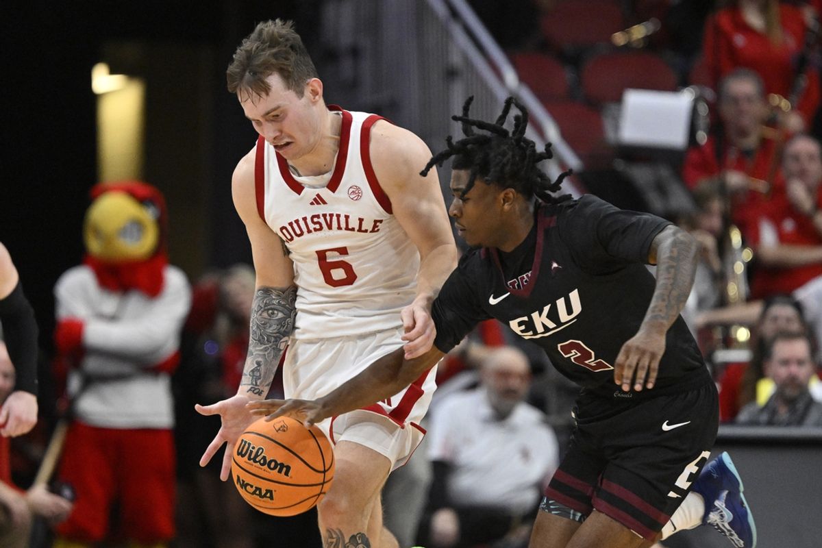 Dec 28, 2024; Louisville, Kentucky, USA;  Eastern Kentucky Colonels guard Jordan Crawford (2) attempts to steal the ball from Louisville Cardinals guard Reyne Smith (6) during the second half at KFC Yum! Center. Louisville won 78-76. Mandatory Credit: Jamie Rhodes-Imagn Images