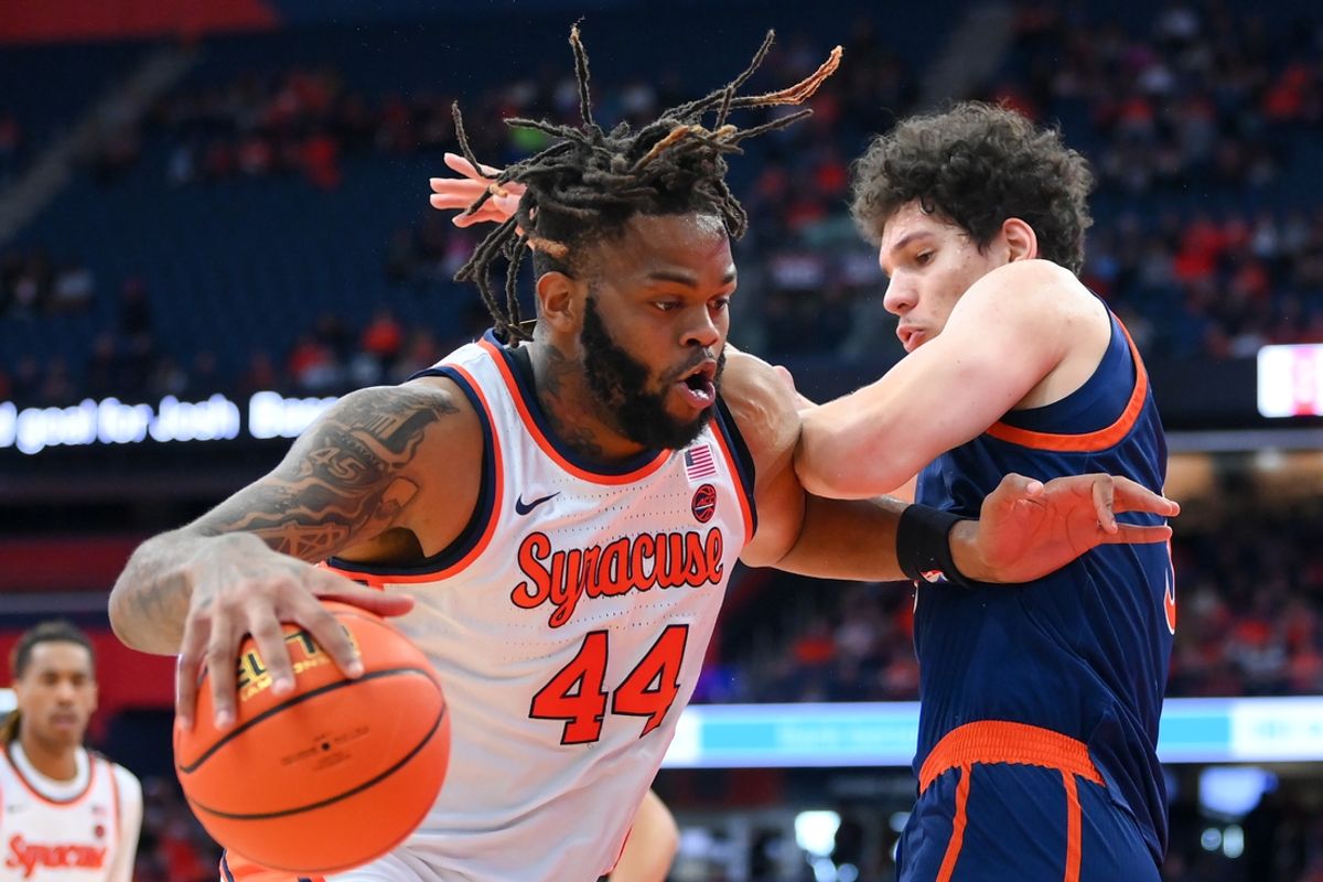 Dec 28, 2024; Syracuse, New York, USA; Syracuse Orange center Eddie Lampkin Jr. (44) drives against Bucknell Bison center Noah Williamson (3) during the first half at the JMA Wireless Dome. Mandatory Credit: Rich Barnes-Imagn Images