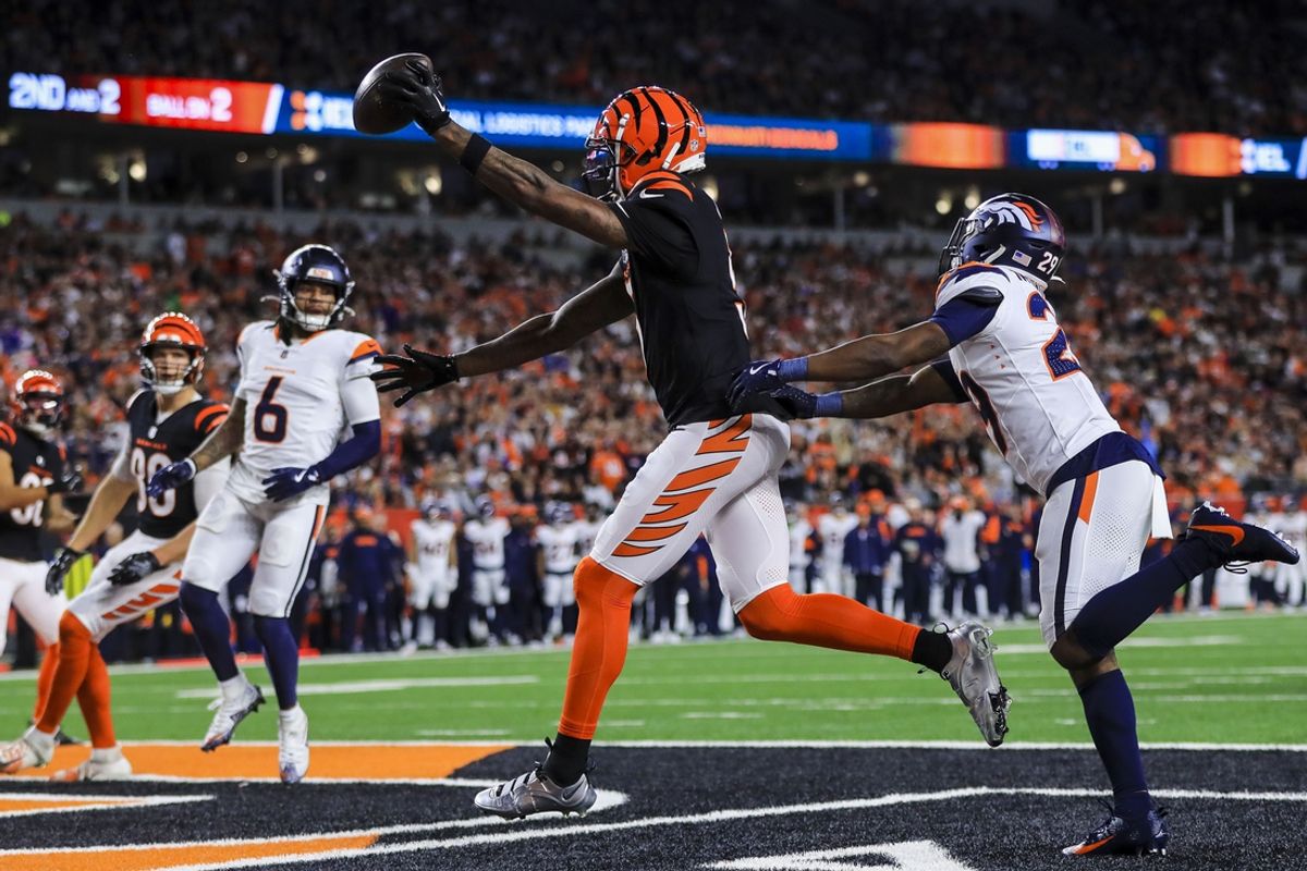 Dec 28, 2024; Cincinnati, Ohio, USA; Cincinnati Bengals wide receiver Tee Higgins (5) catches a pass for a touchdown against Denver Broncos cornerback Ja'Quan McMillian (29) in the first half at Paycor Stadium. Mandatory Credit: Katie Stratman-Imagn Images
