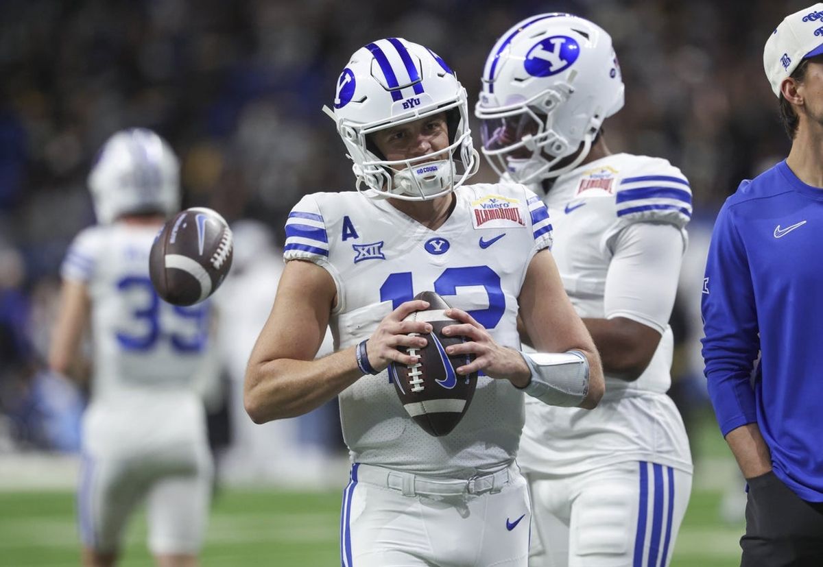 Dec 28, 2024; San Antonio, TX, USA; Brigham Young Cougars quarterback Jake Retzlaff (12) warms up before the game against the Colorado Buffaloes at Alamodome. Mandatory Credit: Troy Taormina-Imagn Images