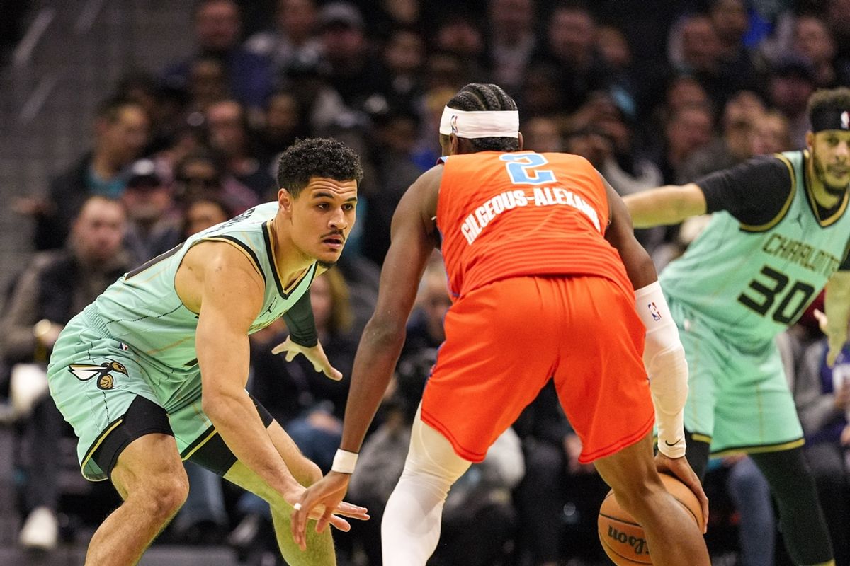 Dec 28, 2024; Charlotte, North Carolina, USA; Charlotte Hornets guard Josh Green (10) on defense against Oklahoma City Thunder guard Shai Gilgeous-Alexander (2) during the first quarter at Spectrum Center. Mandatory Credit: Jim Dedmon-Imagn Images
