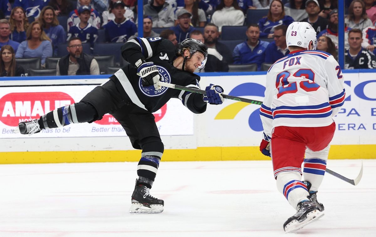Dec 28, 2024; Tampa, Florida, USA; Tampa Bay Lightning center Jake Guentzel (59) shoots as New York Rangers defenseman Adam Fox (23) defends during the first period at Amalie Arena. Mandatory Credit: Kim Klement Neitzel-Imagn Images